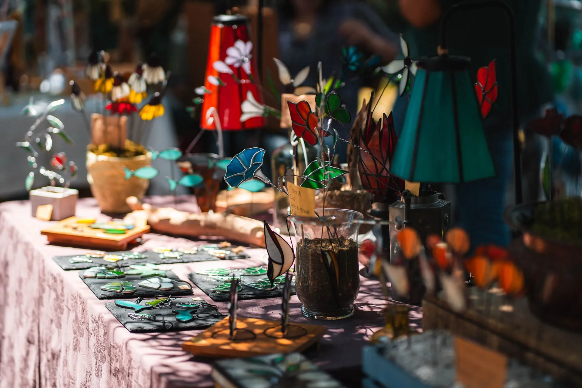 Stained-glass lamps and objects on a stall
