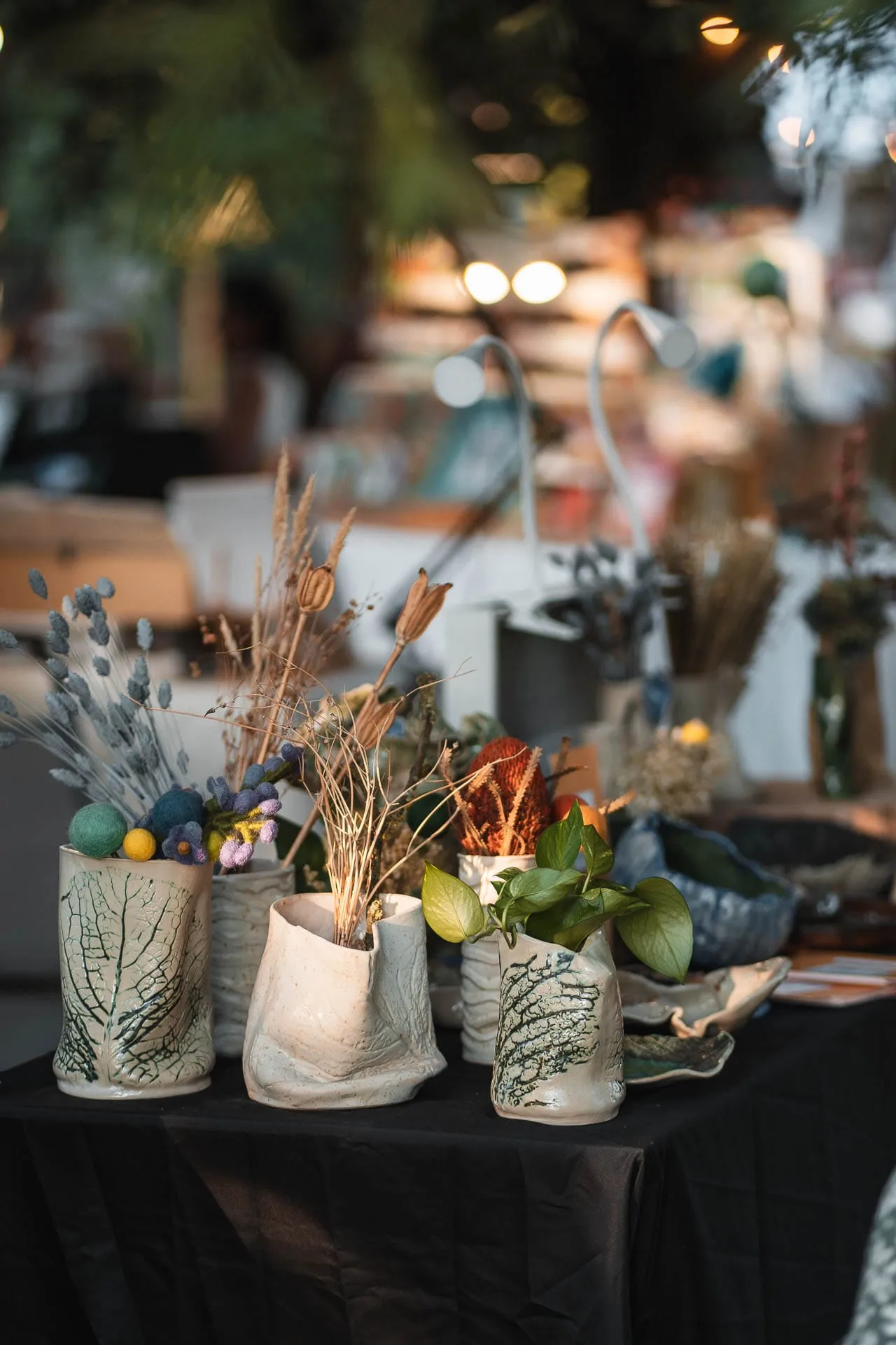 Decorated vases with dried flowers on a stall