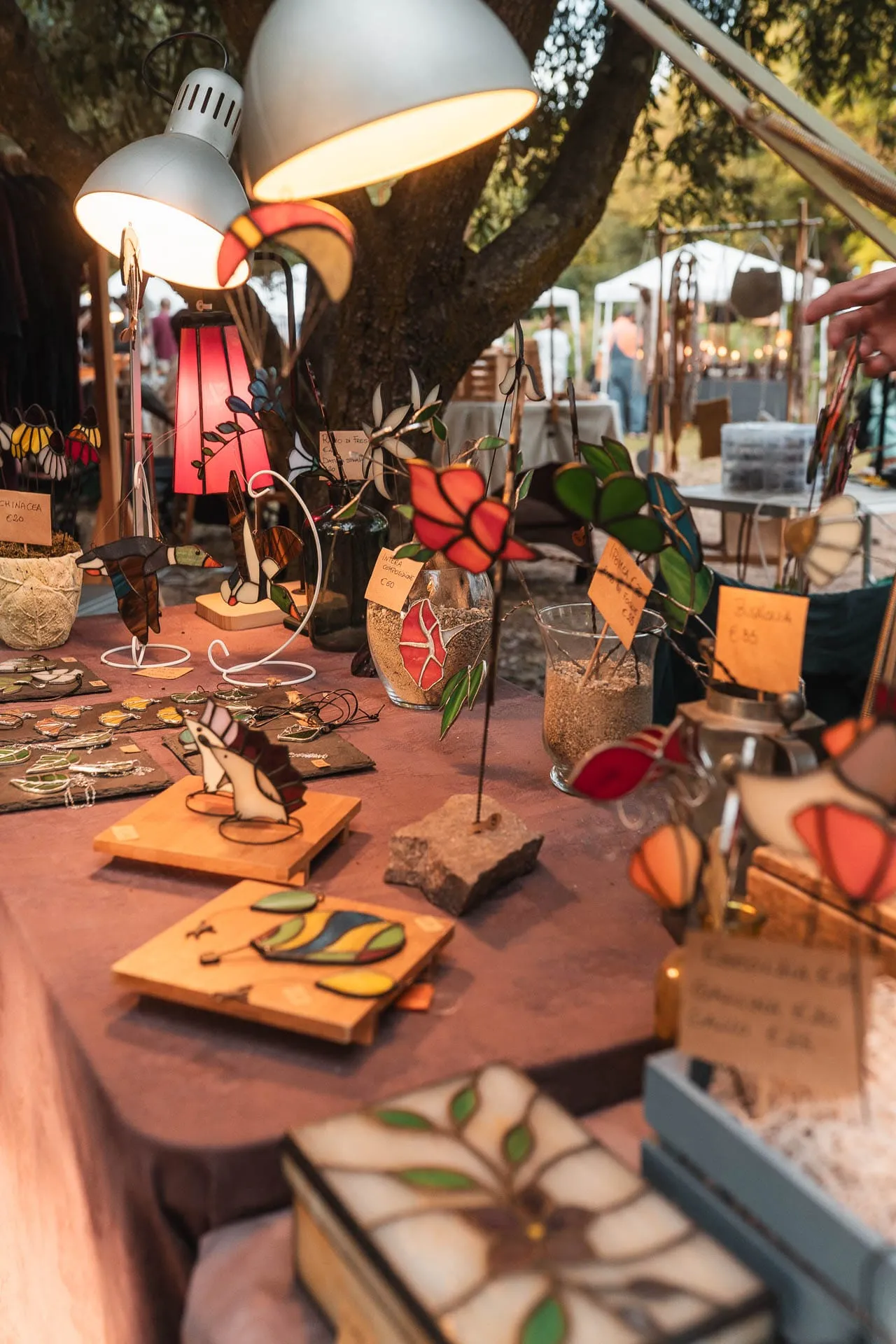 Stained-glass objects on a stall at sunset